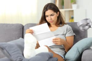 Woman reading insurance claim denial